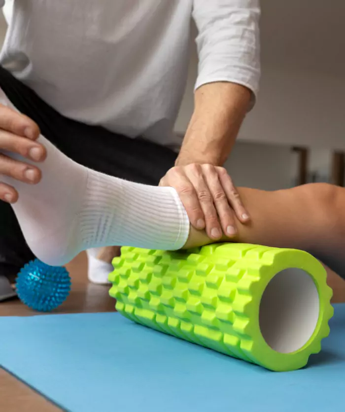 Wood table with porcelain mug, leather journal, brass pen, leather key ring, and a houseplant.